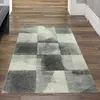 A rug with an abstract checkered pattern is placed on a wooden floor in a hallway. Produktbild-Vorschau