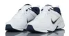 A pair of white and navy Nike athletic shoes are shown against a white background. Voir les images du produit