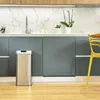 A modern kitchen with gray cabinets, a marble backsplash, and a stainless steel trash can. Produktbild-Vorschau