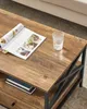 A close-up view of a wooden coffee table with a magazine and a glass of water on it. Náhled obrázku produktu
