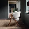 A modern living room with two chairs, a rug, and a doorway leading to another room. Podgląd zdjęcia produktu