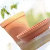 A terracotta plant pot and saucer are shown on a reflective surface with a blurred green background. Náhľad obrázku produktu