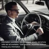 A man in a suit driving a car, wearing a smartwatch and earbuds. Náhled obrázku produktu