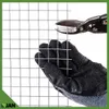 A gloved hand is holding a piece of wire mesh while metal shears are positioned to cut it. Náhled obrázku produktu