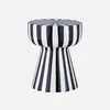 A black and white striped stool against a light gray background. Produktbild-Vorschau