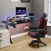 A gaming desk setup in a room with a computer, chair, and accessories. Produktbild-Vorschau