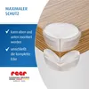Close-up of transparent corner protectors on a wooden table edge. Produktbild-Vorschau
