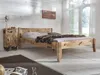 A bedroom scene featuring a wooden bed and a matching nightstand. Produktbild-Vorschau
