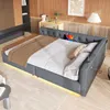 A modern bedroom or living room setting with a grey upholstered sofa bed. Produktbild-Vorschau