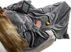A person is lying on a couch, wrapped in a large gray blanket with sleeves, holding an e-reader. Produktbild-Vorschau