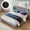 A bed with pillows and a blanket, with a tablet on the bed. The headboard has built-in charging ports. Produktbild-Vorschau