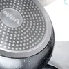 A close-up view of the bottom of a frying pan, showing the textured surface and the brand logo. Anteprima dell’immagine prodotto
