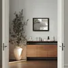 A rectangular wall mirror is displayed above a wooden sideboard in a room with a large potted plant. Produktbild-Vorschau