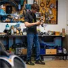 A man working in a workshop with tools and equipment. Anteprima dell’immagine prodotto