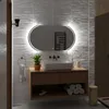 A modern bathroom vanity with a sink, mirror, and accessories. Produktbild-Vorschau