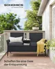 A black rattan bench with cushions and a yellow throw blanket is placed on a wooden deck on a balcony, with trees and sky in the background. Produktbild-Vorschau