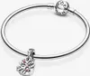 A silver Pandora bracelet with a heart-shaped charm adorned with pink stones and leaves. Produktbild-Vorschau