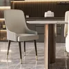 A modern dining room setting with a chair and table. Voir les images du produit
