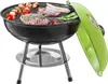 A black charcoal grill with a bright green lid, filled with various foods being grilled, including steaks, sausages, skewers, and asparagus. Voir les images du produit