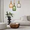 A modern living room scene with three pendant lights hanging above a coffee table and sofa. Produktbild-Vorschau
