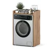 A washing machine with a wooden cabinet and shelf on top, decorated with toiletries and a plant. Voir les images du produit