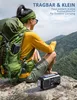 A person with a backpack is sitting on a rock, looking at a mountain landscape. A radio is placed on the rock in front of them. Produktbild-Vorschau