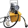 A yellow and silver electric hydraulic pump with a pressure gauge and hoses, set against a white background. Podgląd zdjęcia produktu
