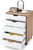 A mobile filing cabinet with five drawers, shown from a diagonal angle with some drawers open to reveal contents. Decorative items are on top. Náhľad obrázku produktu