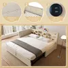 A bed with a headboard featuring shelves and USB charging ports, presented in a room setting with a window and lamp. Podgląd zdjęcia produktu