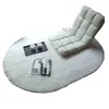 A white fluffy rug with a floor chair, a tray with two cups, and a magazine on it. Anteprima dell’immagine prodotto