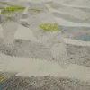 A close-up, angled view of a carpet with a geometric, abstract pattern. Produktbild-Vorschau