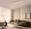 A modern living room with a sofa, armchair, coffee tables, and a ceiling light. Produktbild-Vorschau
