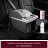 A portable cooler is secured with a seatbelt in the back seat of a car, with a can and a bottle of liquid placed next to it. Podgląd zdjęcia produktu