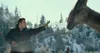 A man interacting with a dinosaur in a snowy, mountainous environment. Náhled obrázku produktu