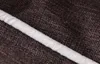 A close-up view of the textured fabric of a pet bed, showing a white piping detail. Produktbild-Vorschau