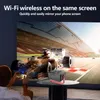 A person is using a smartphone to mirror their screen onto a large projector screen displaying a Formula 1 race. A small projector sits on a table in the foreground. Produktbild-Vorschau