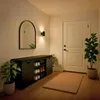 An entryway with a shoe cabinet, mirror, door, and plants. Náhľad obrázku produktu