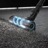 A close-up of a vacuum cleaner head with a visible brush roll and glowing blue suction effect, cleaning a carpet. Produktbild-Vorschau