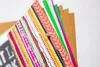 A close-up shot of several sheets of patterned paper fanned out, held together by a small pin. Náhľad obrázku produktu