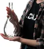 A person is holding a clear glass bottle. Podgląd zdjęcia produktu