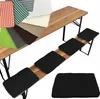 A collection of fabric swatches and black seat cushions displayed on and next to a wooden beer bench. Produktbild-Vorschau