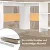 A close-up view of a white L-shaped desk, highlighting its reinforced structure and material. The background shows a living room setting with a sofa. Produktbild-Vorschau