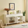A white sideboard with open doors, displaying its interior storage, decorated with flowers and other items. Produktbild-Vorschau