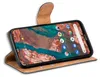 A smartphone in a brown flip case, displayed at an angle on a white background. Podgląd zdjęcia produktu