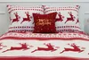 A Christmas-themed bedding set with reindeer and snowflake patterns, featuring two pillows and a duvet cover. Podgląd zdjęcia produktu
