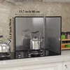 A kitchen scene with a stove, kettles, and a splatter shield. Produktbild-Vorschau