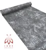 A roll of wallpaper with a textured gray and white pattern, with a logo and text in the bottom left corner. Anteprima dell’immagine prodotto