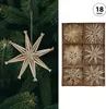 A Christmas tree branch with a straw star ornament, and a box of assorted straw star ornaments. Produktbild-Vorschau
