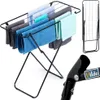 A black metal drying rack with several towels draped over it, shown from a slightly elevated angle. A smaller, folded version of the drying rack is visible in the upper right corner, and a close-up of a joint with the brand logo is in the lower right. Voir les images du produit