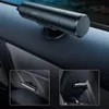 A car safety hammer is shown attached to a car door panel and also in inset images showing its attachment to car seats. Podgląd zdjęcia produktu